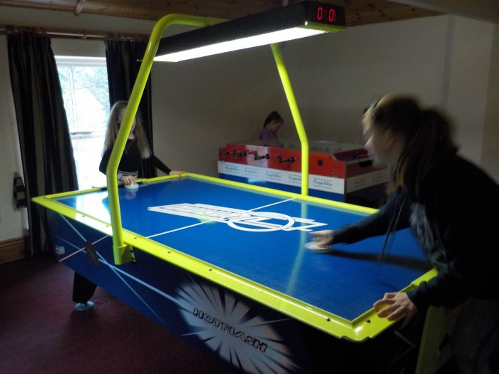 Playing air hockey at Sandybrook Country Park