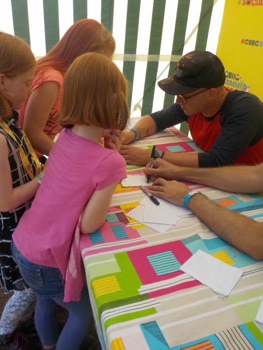 Getting their lanyards signed by Art Ninja at CBBC Summer Social 2018